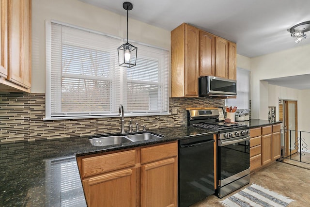 kitchen featuring decorative light fixtures, sink, decorative backsplash, and stainless steel appliances