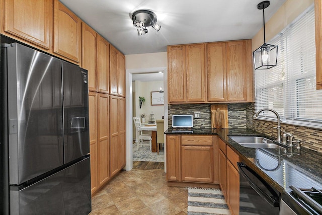 kitchen with pendant lighting, sink, decorative backsplash, black dishwasher, and stainless steel fridge with ice dispenser