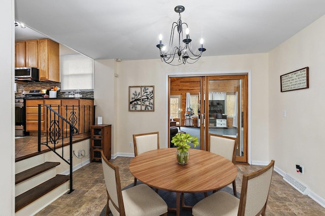 dining space featuring an inviting chandelier