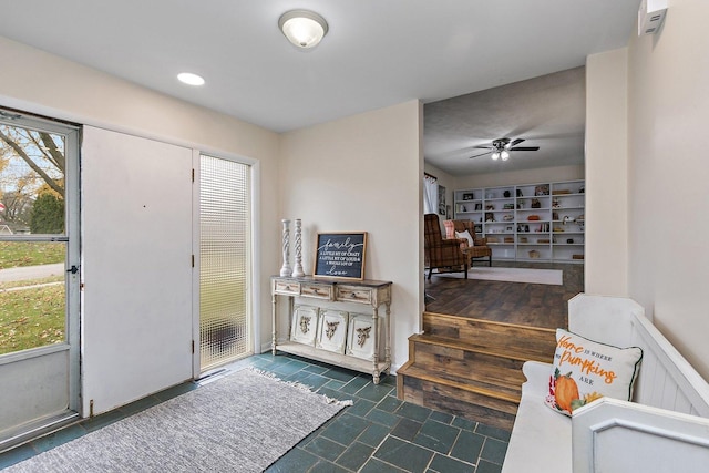 foyer entrance with a wealth of natural light and ceiling fan