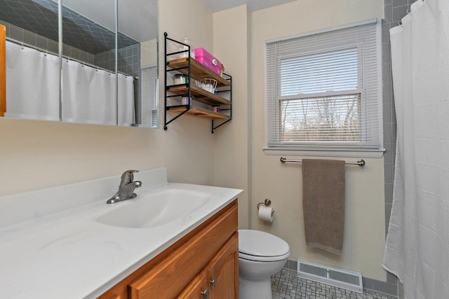 bathroom featuring tile patterned flooring, vanity, and toilet