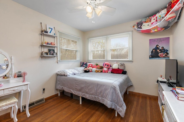 bedroom with ceiling fan and dark hardwood / wood-style flooring