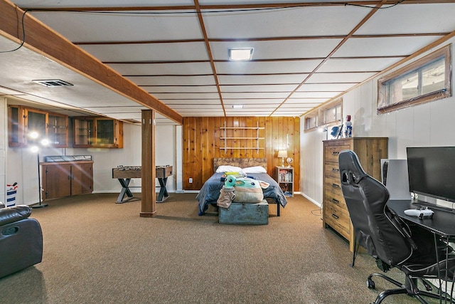 bedroom featuring carpet and wood walls