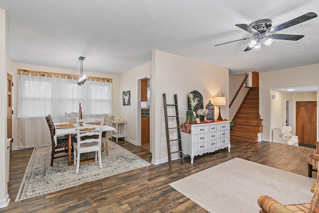 dining space with ceiling fan and dark hardwood / wood-style flooring