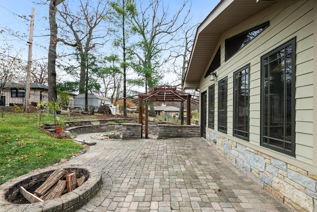 view of patio / terrace with a gazebo and a fire pit