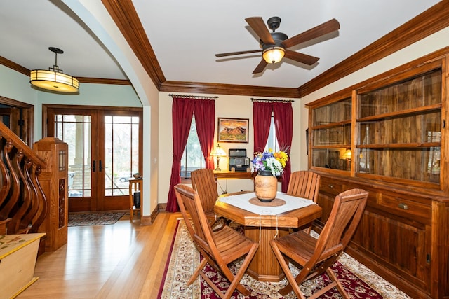 dining area featuring french doors, light hardwood / wood-style flooring, ceiling fan, and crown molding