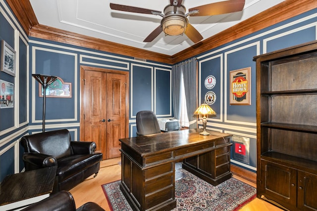 home office with light wood-type flooring and ornamental molding