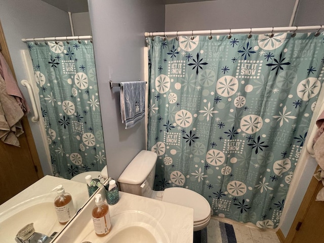 bathroom featuring toilet, vanity, and a shower with shower curtain