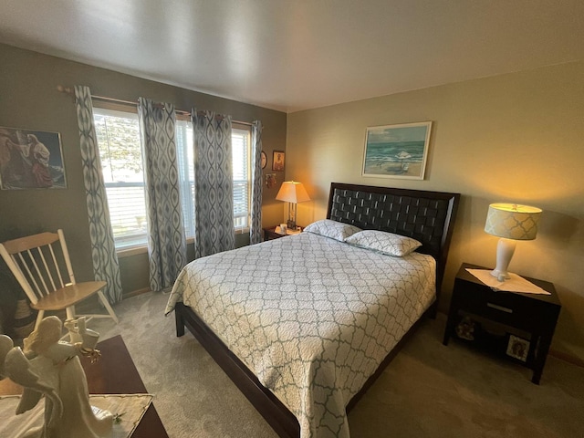 carpeted bedroom featuring multiple windows