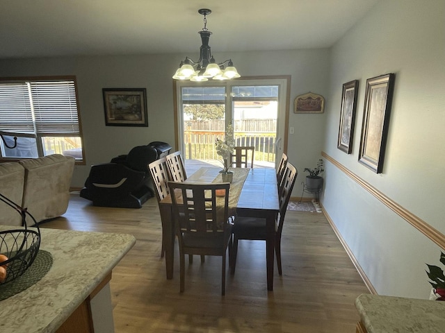 dining area featuring dark hardwood / wood-style flooring and a chandelier