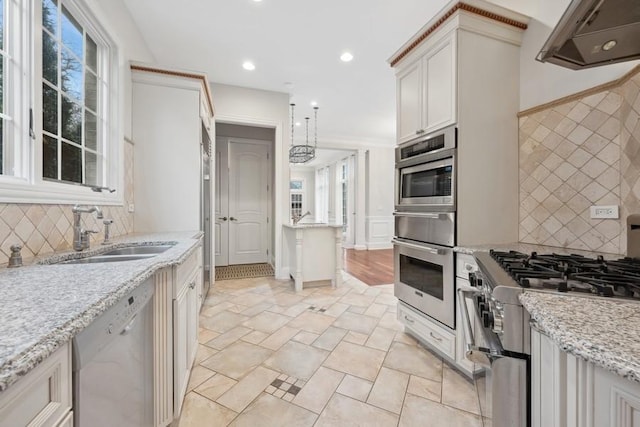 kitchen with pendant lighting, ventilation hood, sink, light stone countertops, and stainless steel appliances