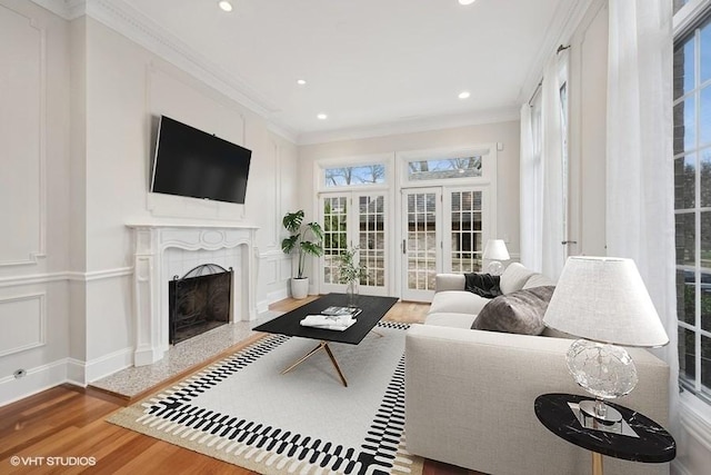 living room featuring hardwood / wood-style flooring and crown molding