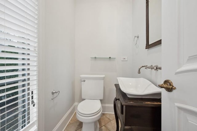 bathroom with tile patterned flooring, vanity, and toilet