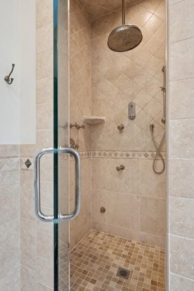 bathroom featuring a shower with shower door