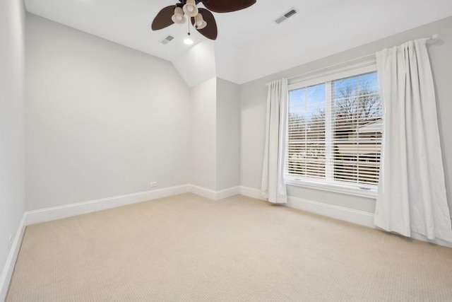 carpeted empty room featuring ceiling fan and lofted ceiling