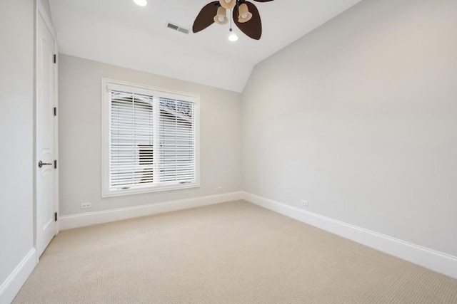 unfurnished room featuring ceiling fan, light colored carpet, and vaulted ceiling