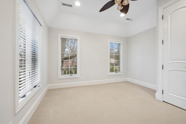 unfurnished room featuring light colored carpet, ceiling fan, and a healthy amount of sunlight