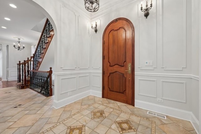 foyer entrance featuring an inviting chandelier