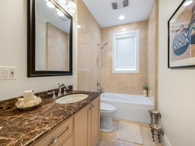 full bathroom with toilet, vanity, tile patterned floors, and tiled shower / bath