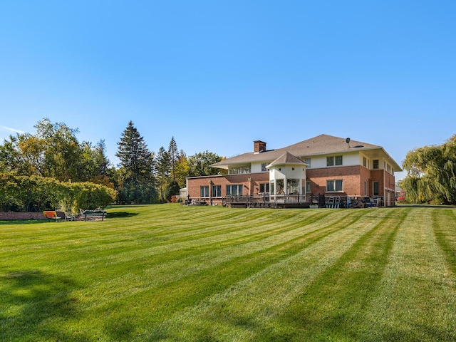 rear view of house with a yard