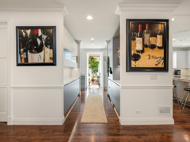 hall featuring crown molding and dark wood-type flooring