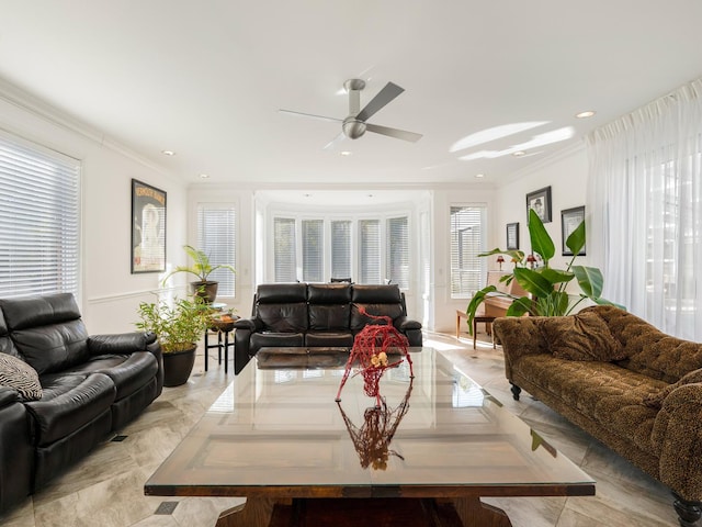 living room with ornamental molding, ceiling fan, and a healthy amount of sunlight