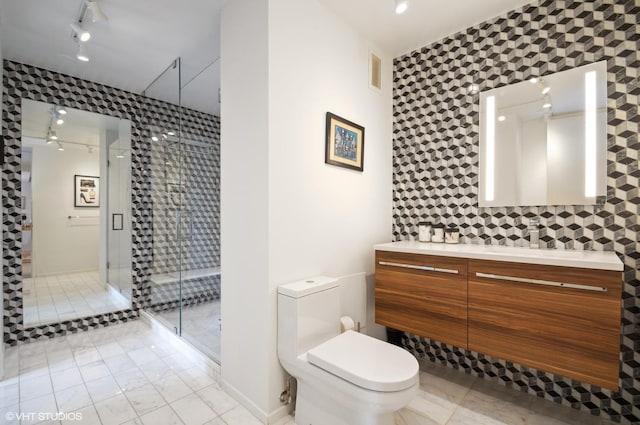 bathroom with vanity, a shower with shower door, and toilet