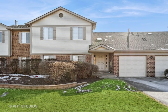 view of front of home featuring a garage and a front lawn