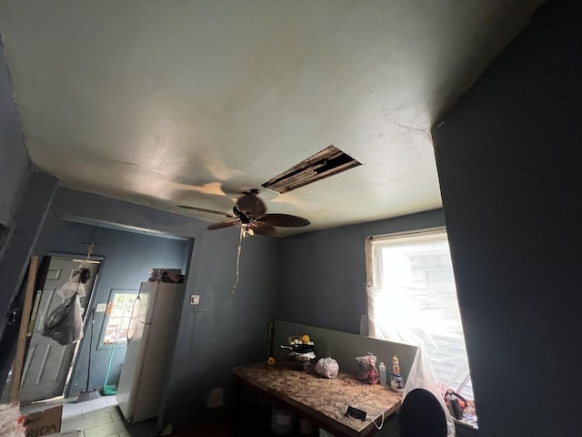 bedroom featuring white fridge and ceiling fan