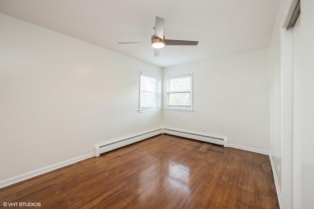 empty room with a baseboard heating unit, ceiling fan, and hardwood / wood-style floors