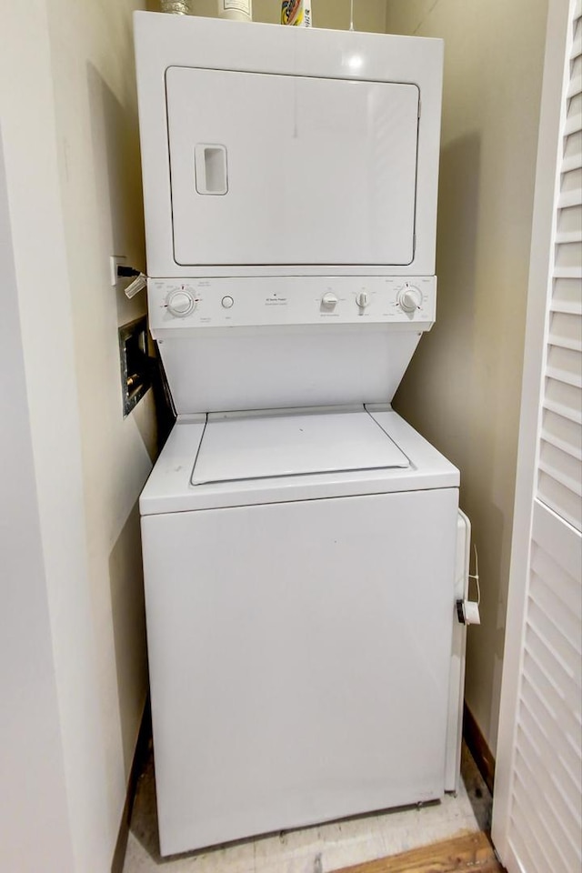 clothes washing area with stacked washer / drying machine