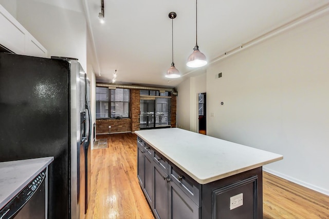 kitchen featuring stainless steel fridge with ice dispenser, a center island, light hardwood / wood-style floors, and decorative light fixtures