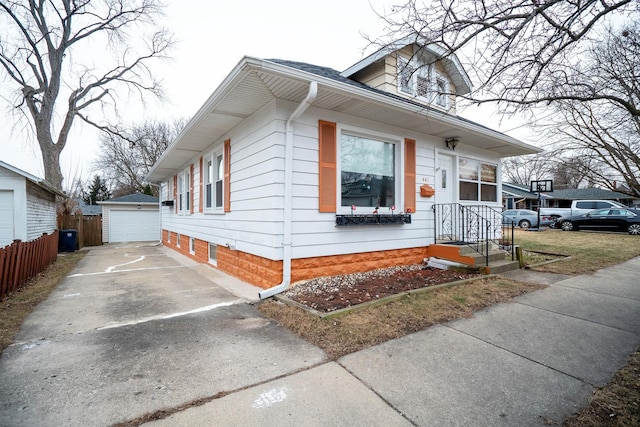 view of front of property with a garage and an outdoor structure