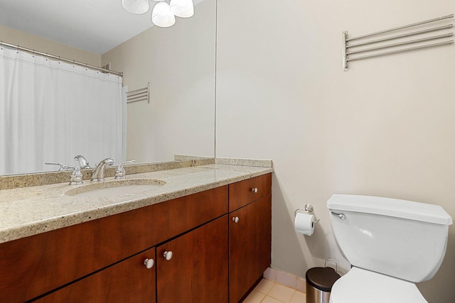 bathroom with tile patterned floors, vanity, and toilet