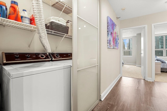 washroom with separate washer and dryer and wood-type flooring