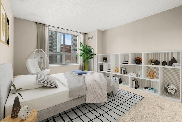 carpeted bedroom with a textured ceiling