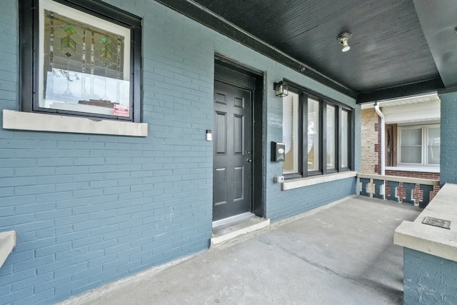 doorway to property featuring covered porch