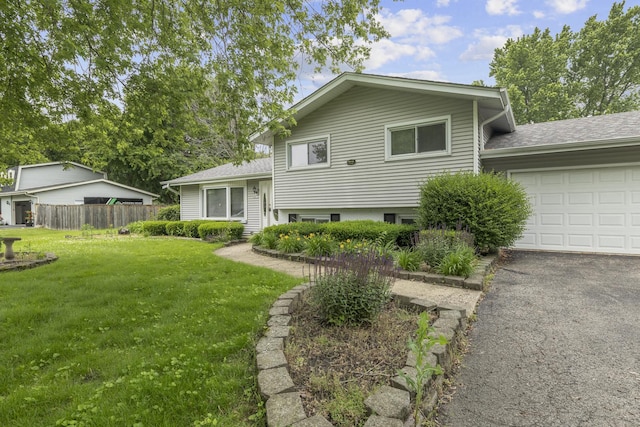 split level home featuring a front yard and a garage