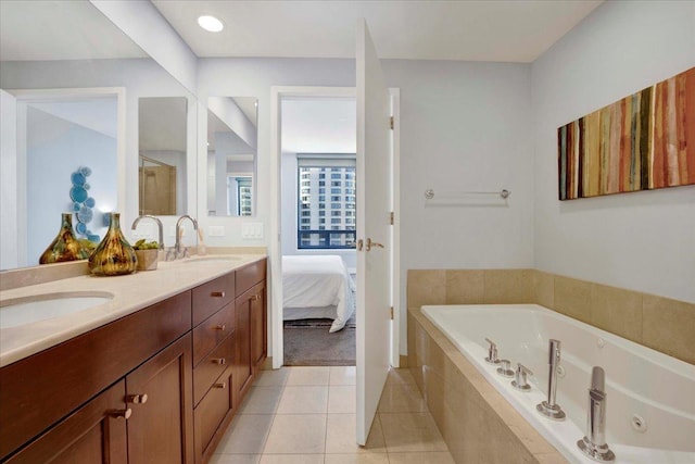 bathroom featuring vanity, a relaxing tiled tub, and tile patterned floors