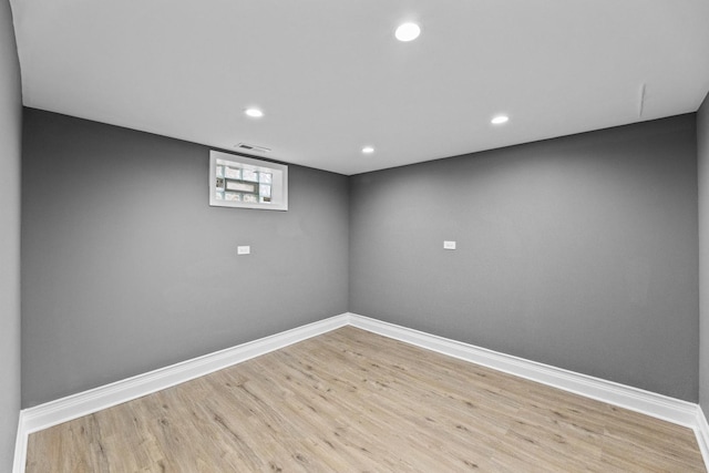 basement with light hardwood / wood-style flooring