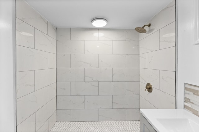 bathroom with vanity and tiled shower