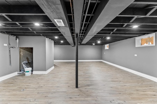 basement with wood-type flooring