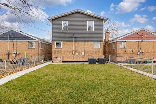 back of property with a yard and central air condition unit