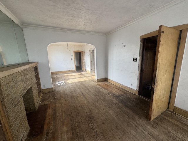 hallway featuring crown molding, dark wood-type flooring, and a textured ceiling