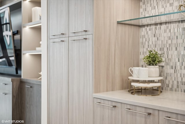 kitchen featuring light brown cabinets and backsplash