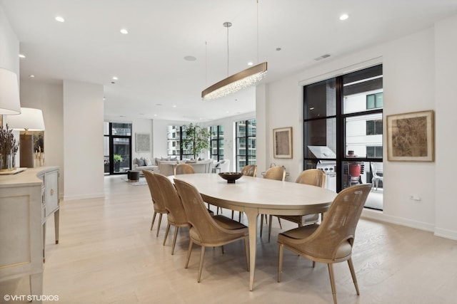 dining space with light hardwood / wood-style flooring