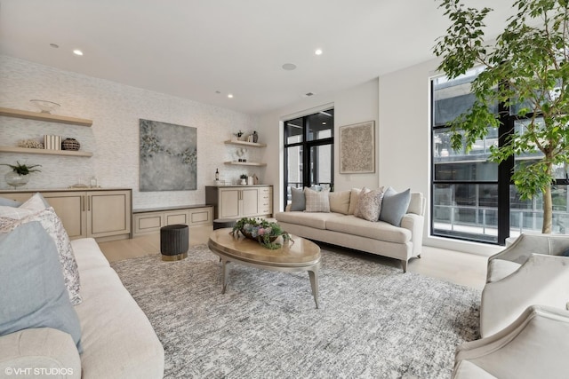 living room with a wealth of natural light and light hardwood / wood-style flooring