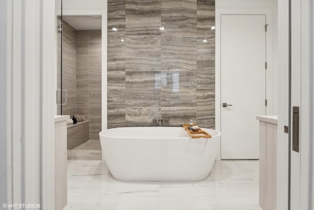 bathroom featuring a tub and tile walls