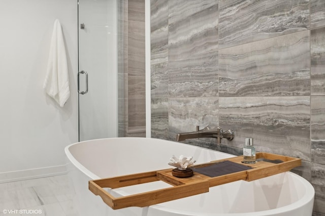 bathroom with a tub to relax in