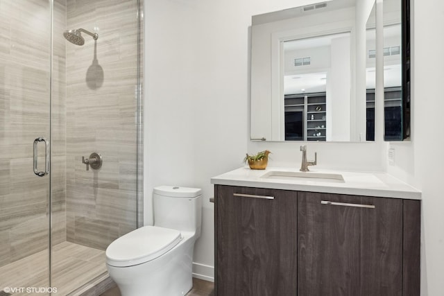 bathroom featuring vanity, toilet, and walk in shower